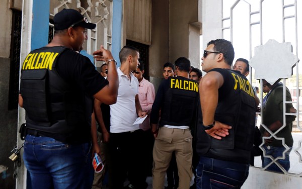 فالكون : 40 ألف جنيه خسائرنا في أول أسبوع للدراسة الجامعية 1 Personnel from Falcon, a private security company, conduct searches as students arrive for a new academic year at the main gate of Al-Azhar University during a protest conducted by a pro-Muslim Brotherhood student movement known as the Students Against the Coup, in Nasr City district October 12, 2014. Universities in Egypt opened on Saturday for the new semester with long queues due to increased security measures such as requiring students to present their identification cards and having their bags inspected, according to local media Al-Ahram's Arabic website. REUTERS/Amr Abdallah Dalsh (EGYPT - Tags: CIVIL UNREST EDUCATION)