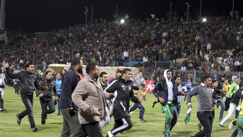 Soccer fans flee from inside the Port Said Staudim