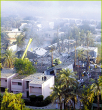 Smoke hangs over a bomb-damaged residential complex near the Saudi royal palaces, in background, in Riyadh Sunday, Nov. 9, 2003. At least 17 people died and 122 were injured in Saturday's attack that the Saudi government has attributed to al-Qaida.(AP Photo/John Moore)