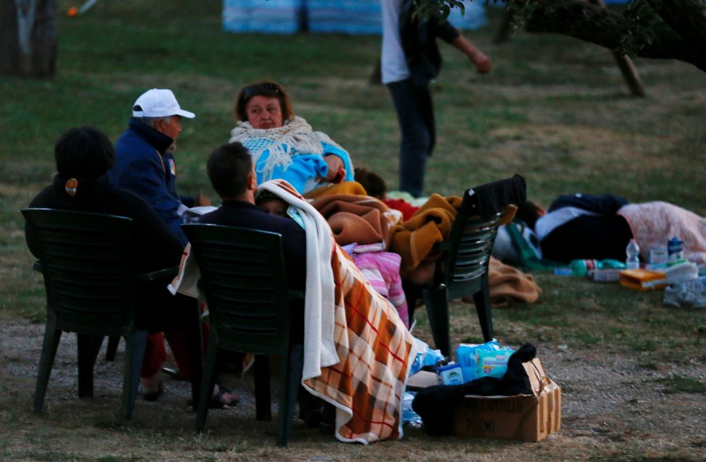 People cover themselves with blankets as they prepare to spend the night in the open following the earthquake in Amatrice, central Italy, August 24, 2016. REUTERS/Stefano Rellandini