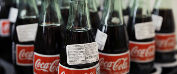 FILE - In this July 9, 2015, file photo, bottles of Coca-Cola are on display at a Haverhill, Mass., supermarket. On Wednesday, April 20, 2016, Coca-Cola Co., reports financial results. (AP Photo/Elise Amendola, File)