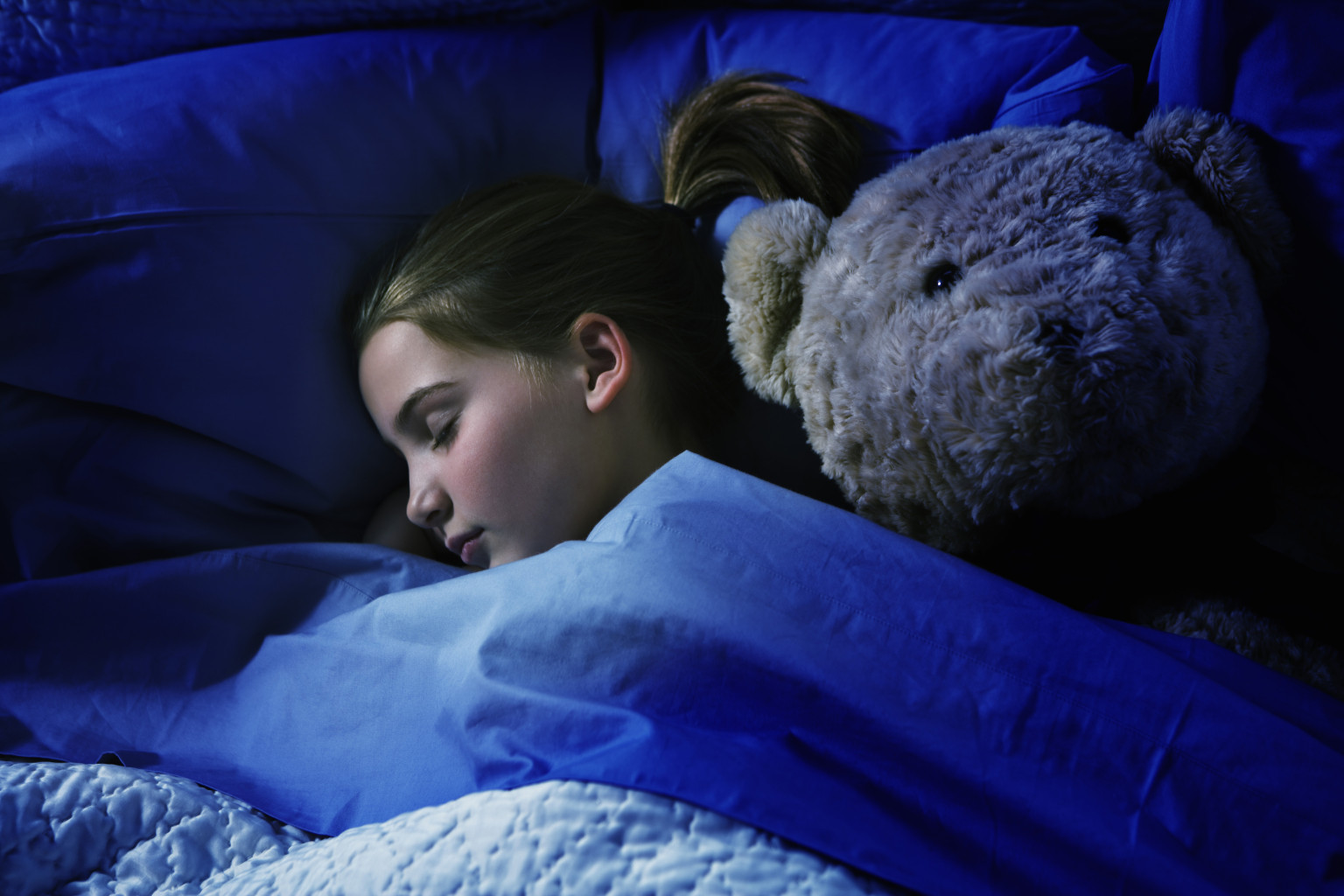 Sleeping girl with teddy bear. 